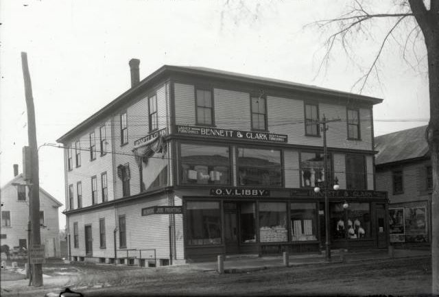 Historic black and white photograph of a two-story commercial building in Sanford, Maine, featuring signs for 'Bennett & Clark' and 'O.V. Libby' on the storefront.