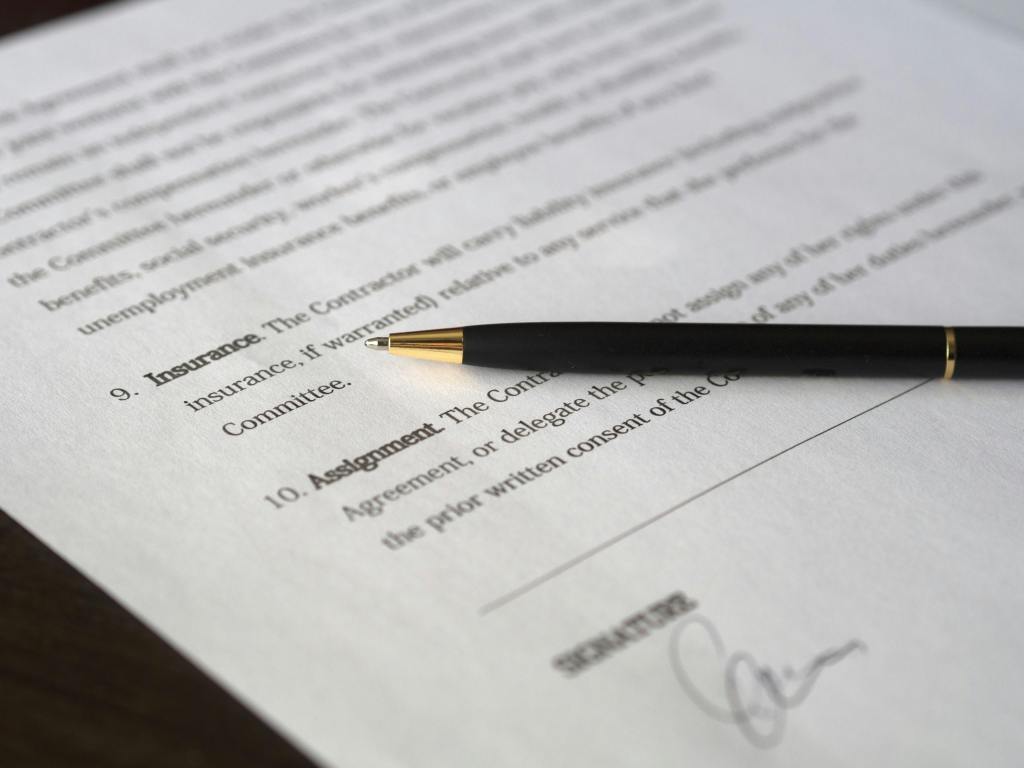 pexels-photo-261679-261679 Close-up image of a business contract and pen, signed and ready for agreement.